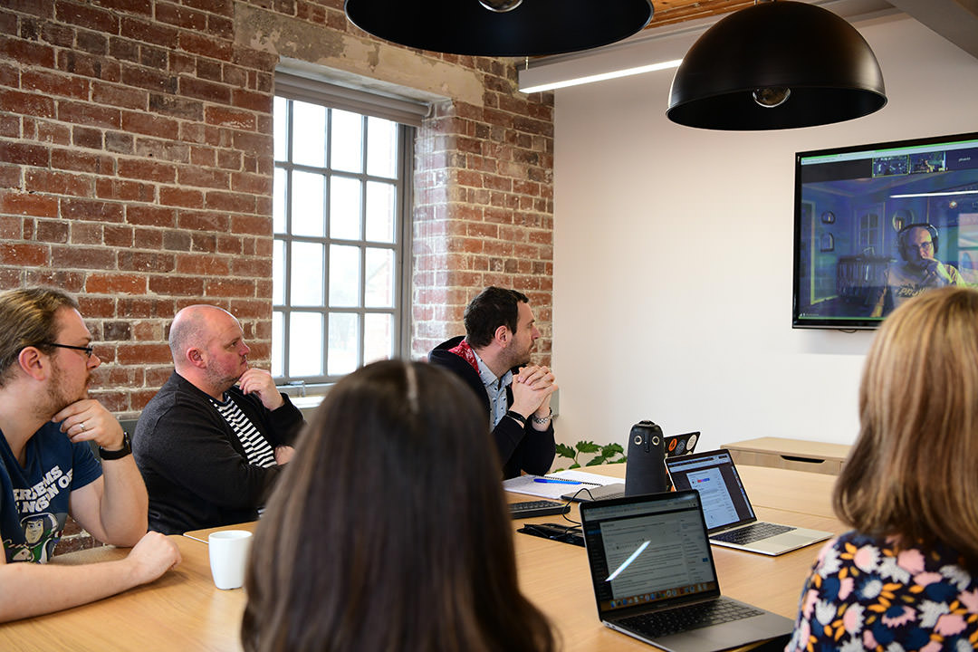 People in a meeting with someone participating remotely