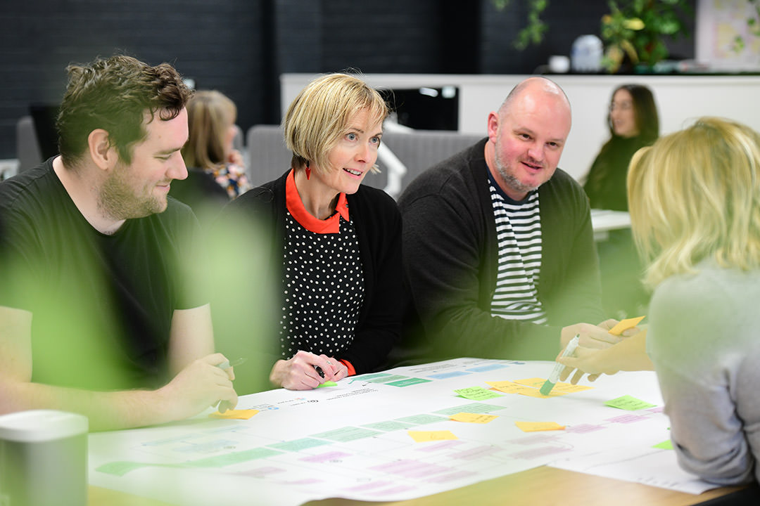 People discussing a chart in a meeting