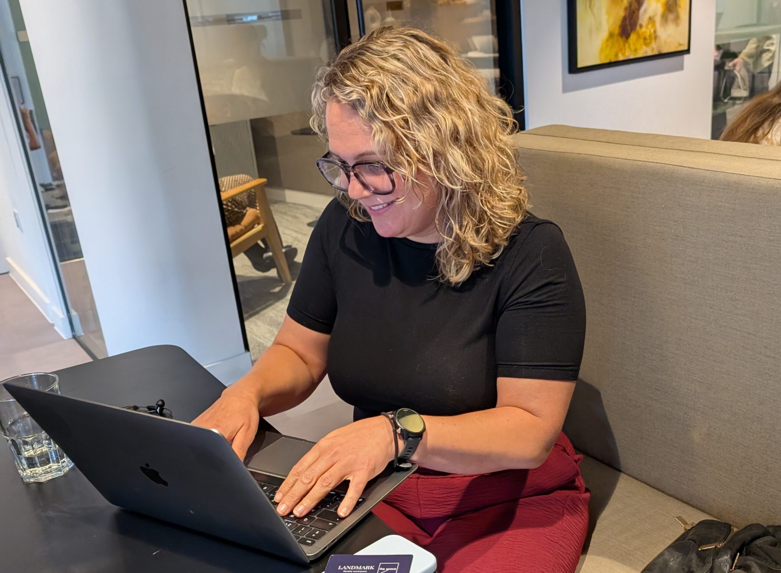 Adelle sat working on a laptop