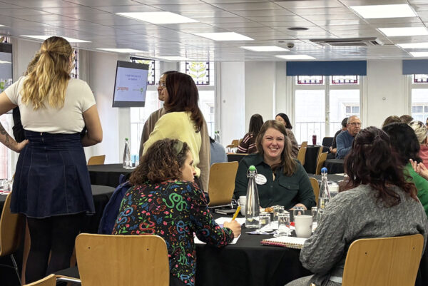 A group of people talking at UKCharityCamp 2025