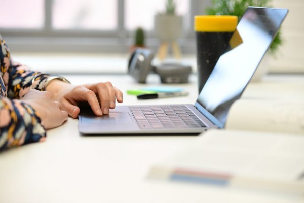 A person typing on a laptop