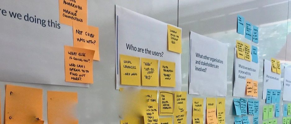 Photo of the questions and sticky notes answers on a wall.